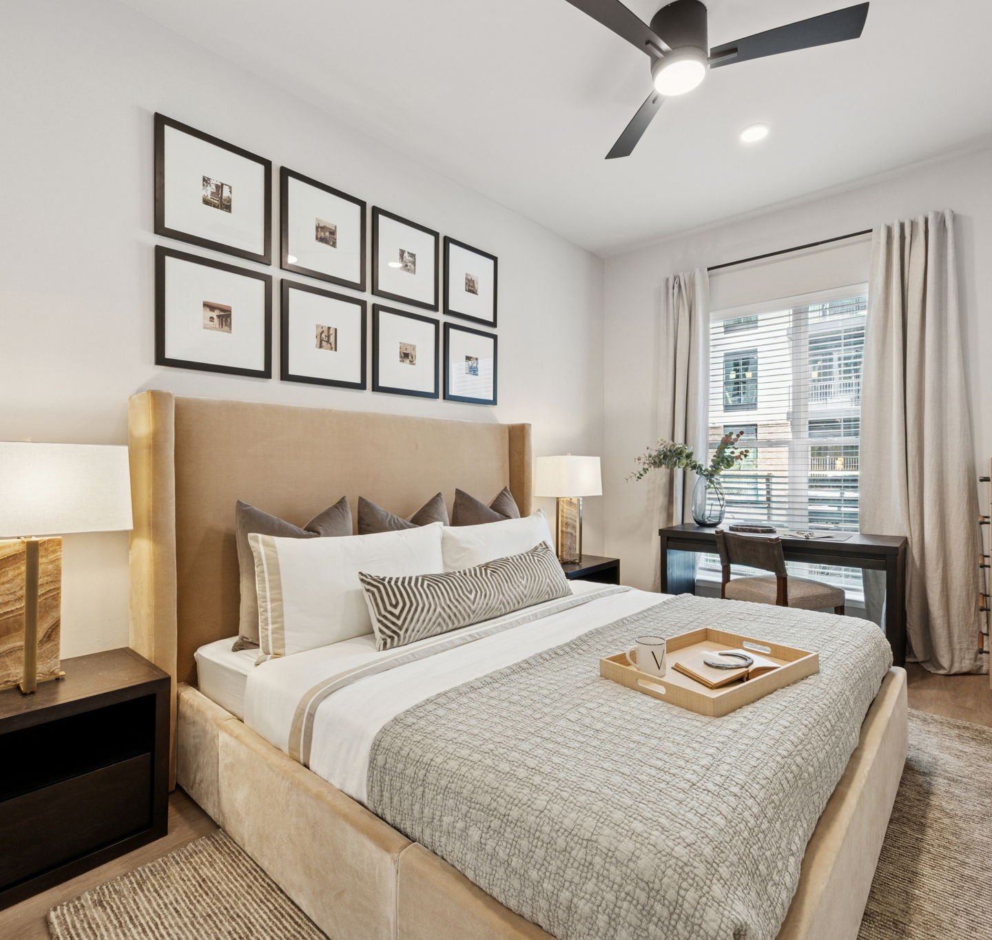 bedroom with a large window and ceiling fans