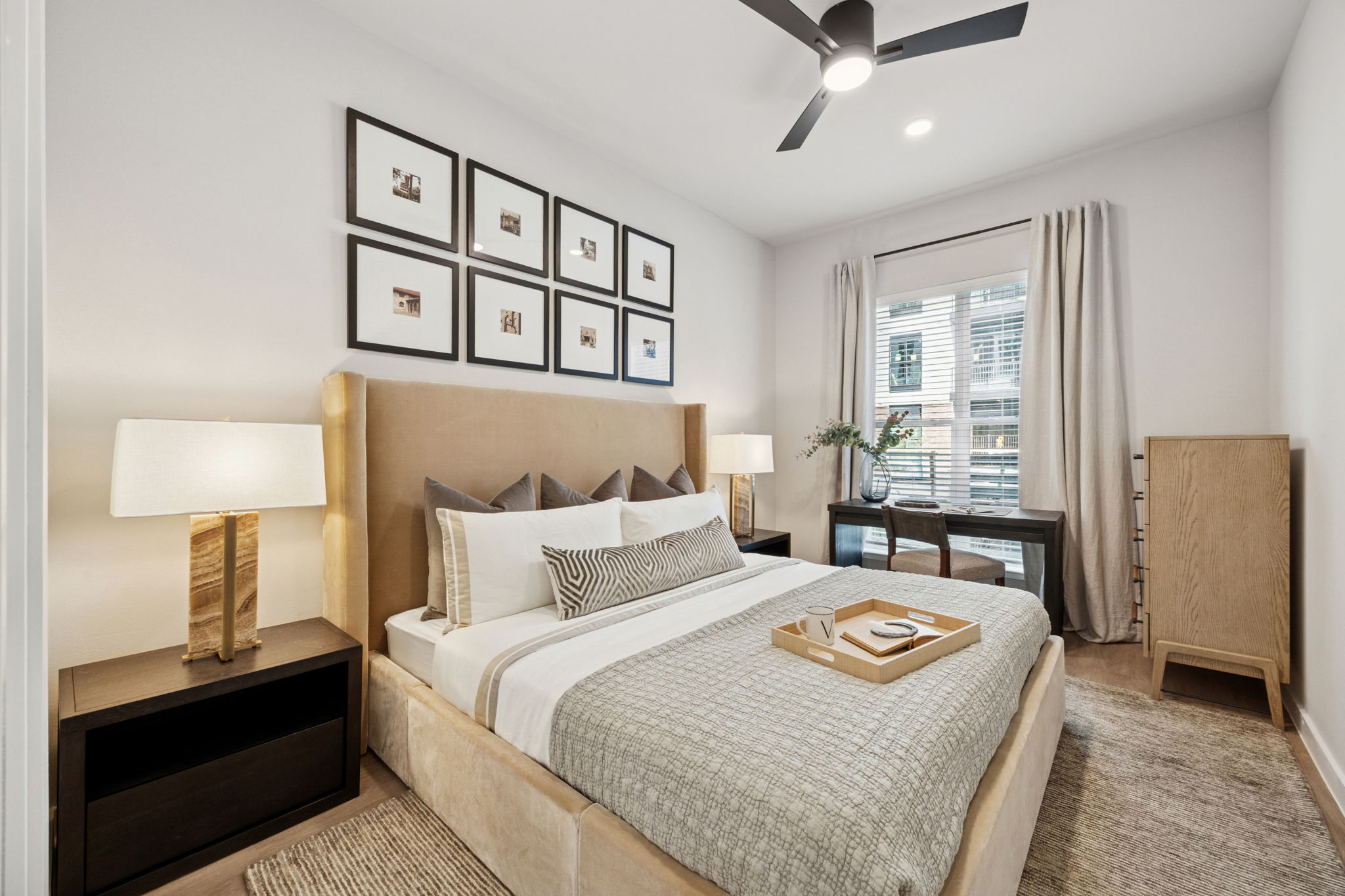 bedroom with a large window and ceiling fans