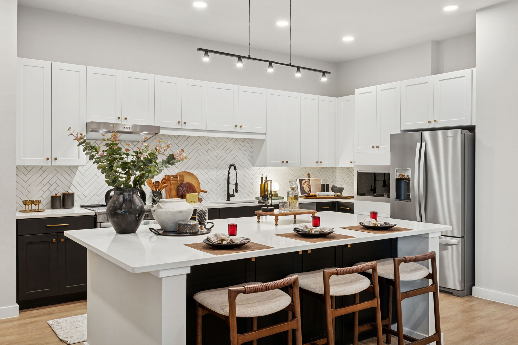 Kitchen with stainless steel appliances and large island with wood flooring
