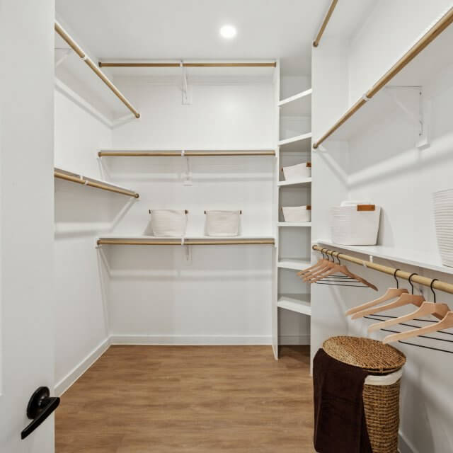 large walk in closet with built in shelving